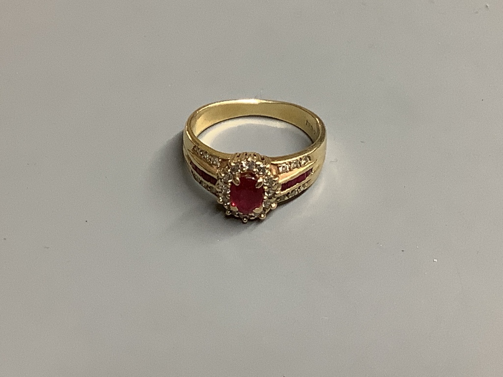 A modern 14 K yellow metal, ruby and diamond cluster ring, size M, gross 3.9 g.